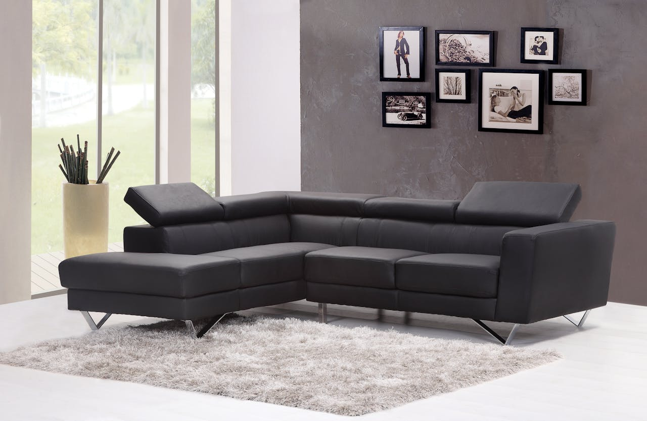 The Art of Drawing Readers In: Your attractive post title goes here Contemporary living room featuring a sleek black sectional sofa and chic wall art.